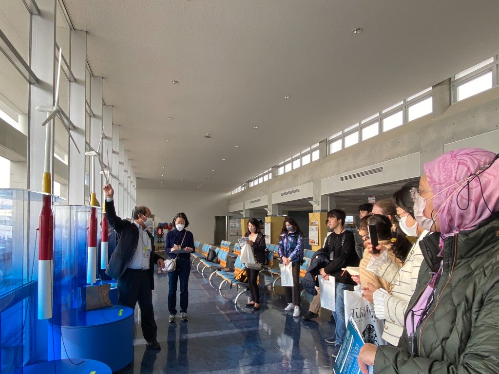 Mr. Kondo explains the off-shore wind turbine "Hamankaze" in Goto city
